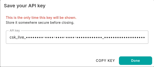The Save your API key dialog showing a masked key